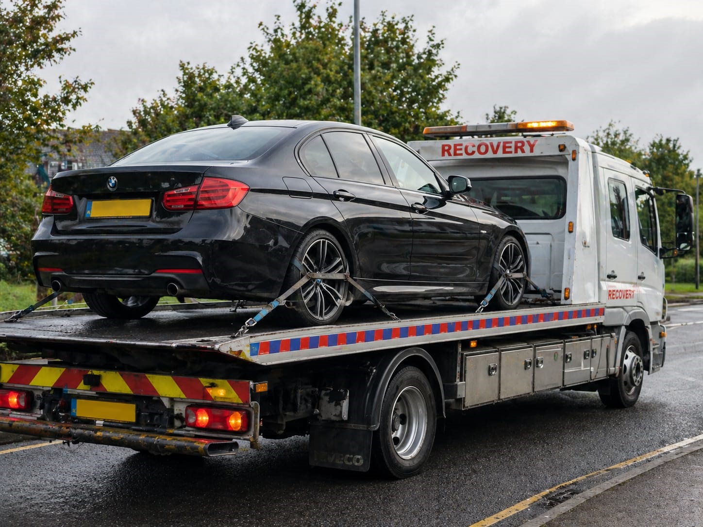Breakdown recovery truck loading a broken down car on a Stoke-on-Trent road